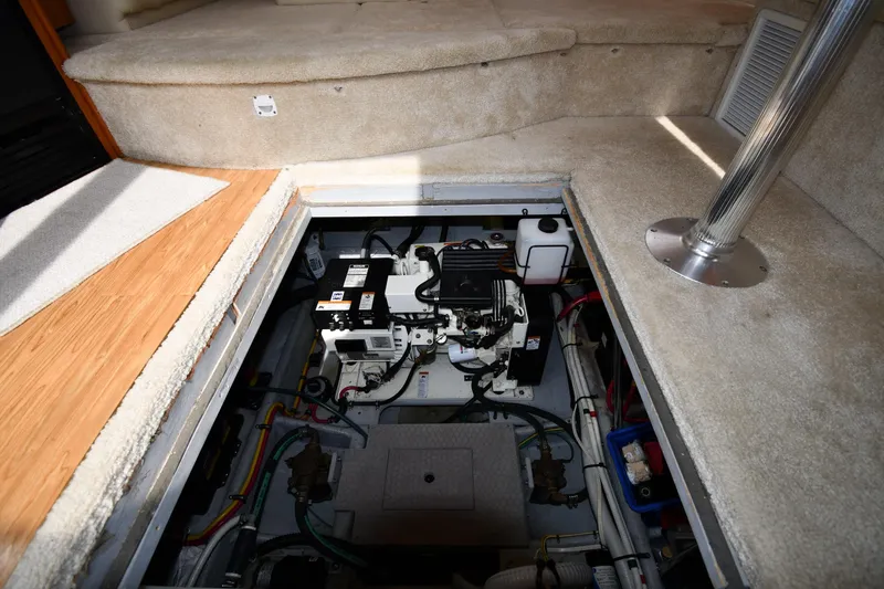 Slide: The Image of Engine compartment of a 2000 Silverton 392 Motor Yacht, showcasing mechanical components and wiring. - 60