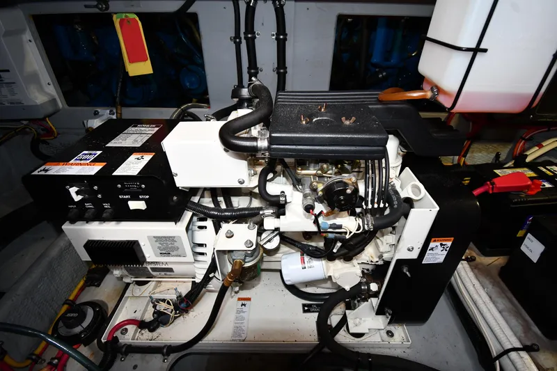 Slide: The Image of Engine room of a 2000 Silverton 392 Motor Yacht, featuring a generator and wiring. - 61