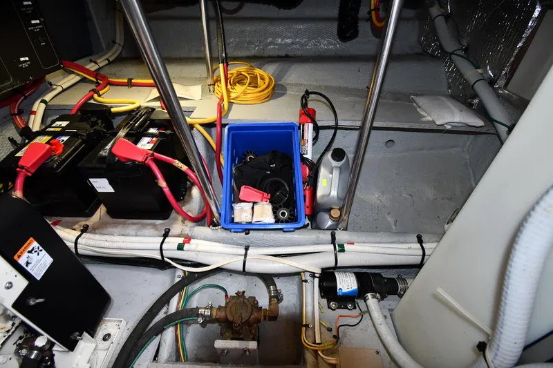 Slide: The Image of Engine room of 2000 Silverton 392 Motor Yacht with batteries and maintenance tools. - 63