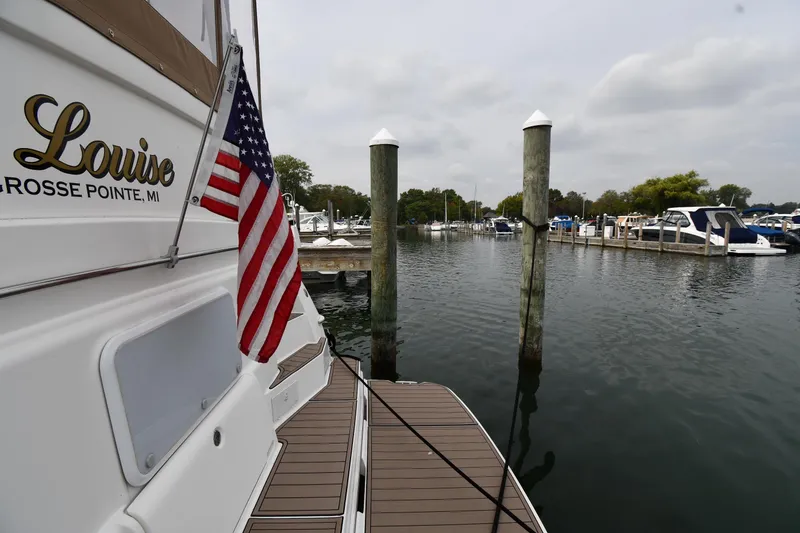 Slide: The Image of 2000 Silverton 392 Motor Yacht docked with American flag, Grosse Pointe marina. - 9