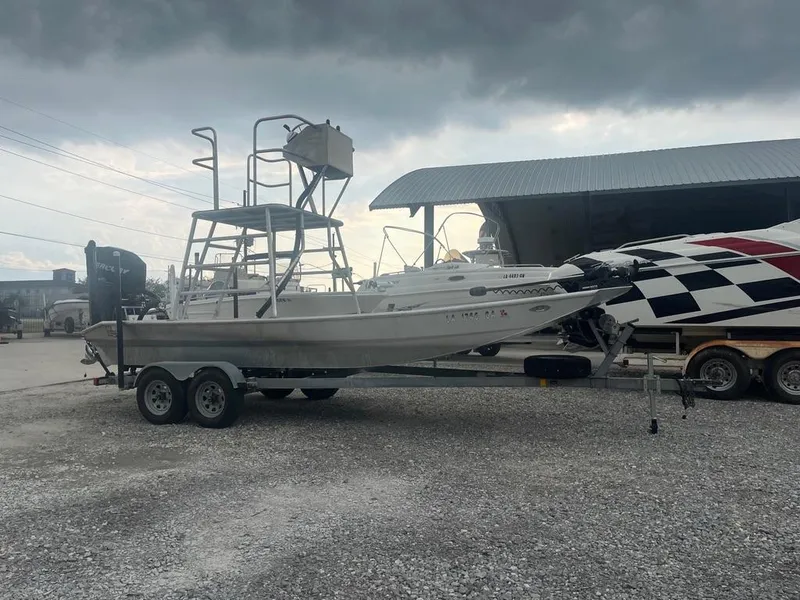 The Image of 2012 Sportsman Custom Build boat on trailer under cloudy sky. - 2
