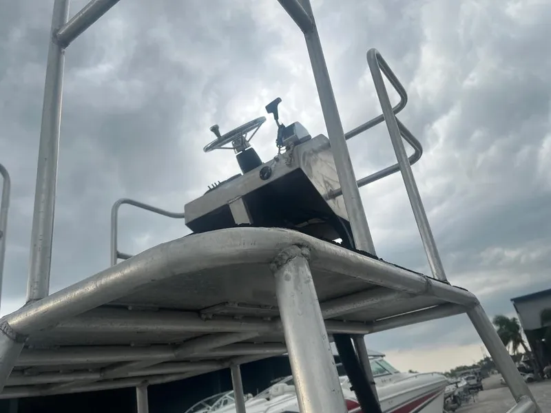 Slide: The Image of 2012 Sportsman Custom Build boat tower under cloudy sky at marina. - 4