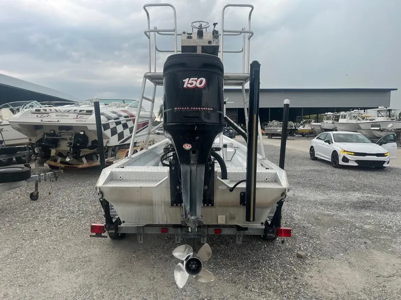 Slide: The Image of 2012 Sportsman Custom Build boat with 150 HP outboard motor in a marina. - 5