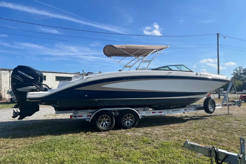 The Image of 2017 Sea Ray SDX 290 Outboard boat on trailer, under clear blue sky. - 0