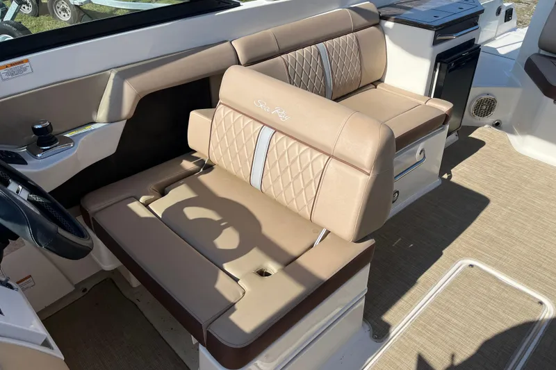 Slide: The Image of 2017 Sea Ray SDX 290 Outboard boat interior with beige seating and steering console. - 10