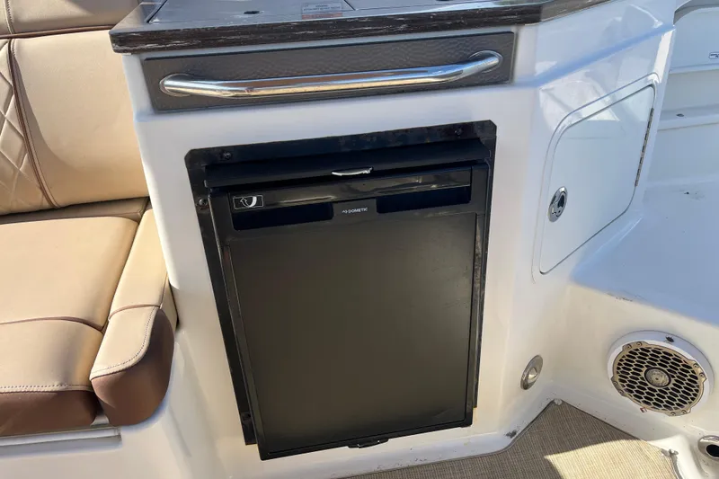 Slide: The Image of 2017 Sea Ray SDX 290 Outboard interior with built-in mini fridge and seating. - 12