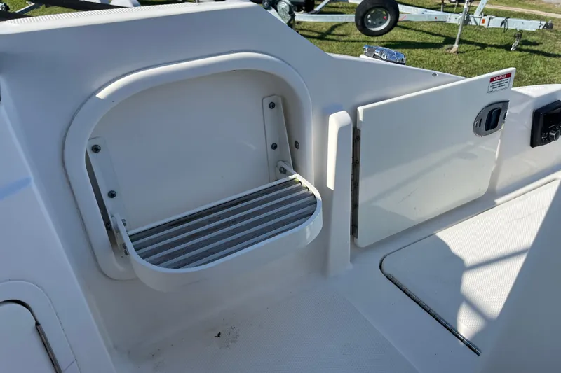 Slide: The Image of 2017 Sea Ray SDX 290 Outboard boat interior with storage compartment and step. - 14