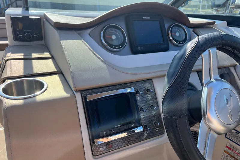 Slide: The Image of 2017 Sea Ray SDX 290 Outboard dashboard with steering wheel and navigation controls. - 15