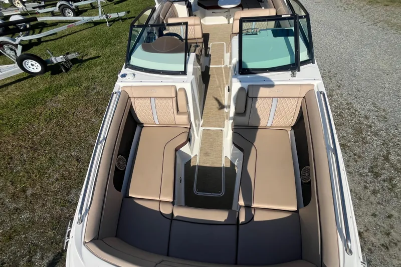 Slide: The Image of 2017 Sea Ray SDX 290 Outboard boat interior with tan seating and open deck layout. - 21