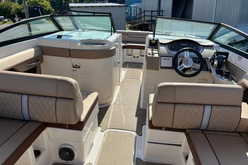 Slide: The Image of 2017 Sea Ray SDX 290 Outboard boat interior with beige seating and modern dashboard. - 4