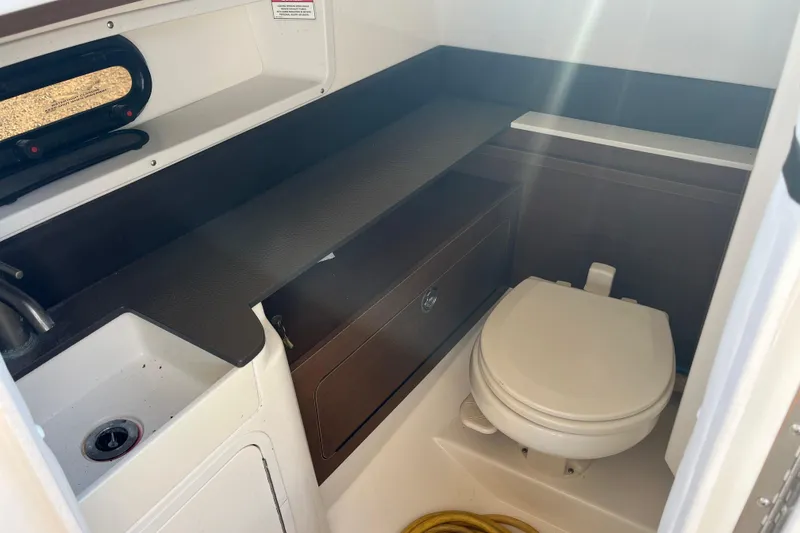 Slide: The Image of 2017 Sea Ray SDX 290 Outboard boat bathroom with sink and toilet. - 6