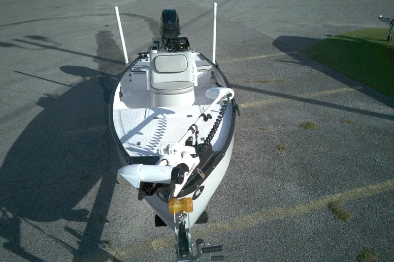 Slide: The Image of 2023 Santee 16CC boat with motor and seating, parked on asphalt. - 4