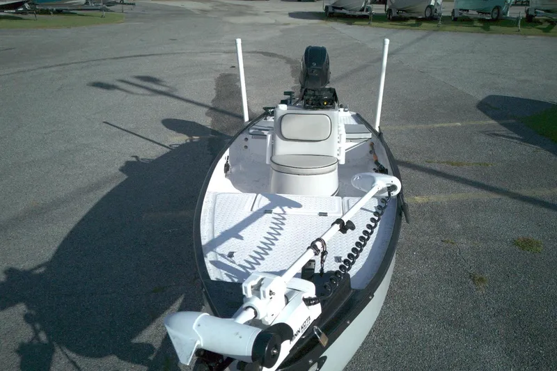 Slide: The Image of 2023 Santee 16CC boat with motor and seating, parked on asphalt. - 6