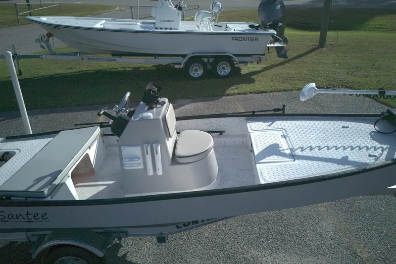 Slide: The Image of 2023 Santee 16CC boat with console and seating, parked on a trailer. - 7