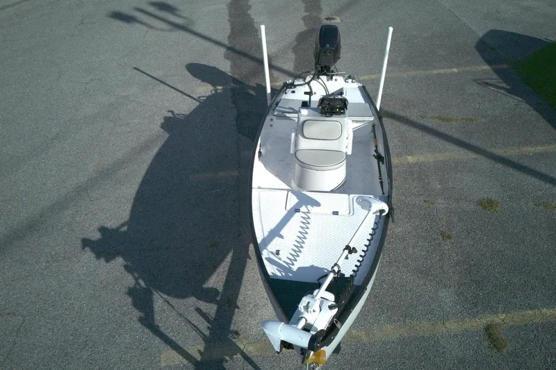 Slide: The Image of 2023 Santee 16CC boat with motor, parked on asphalt, top view. - 9