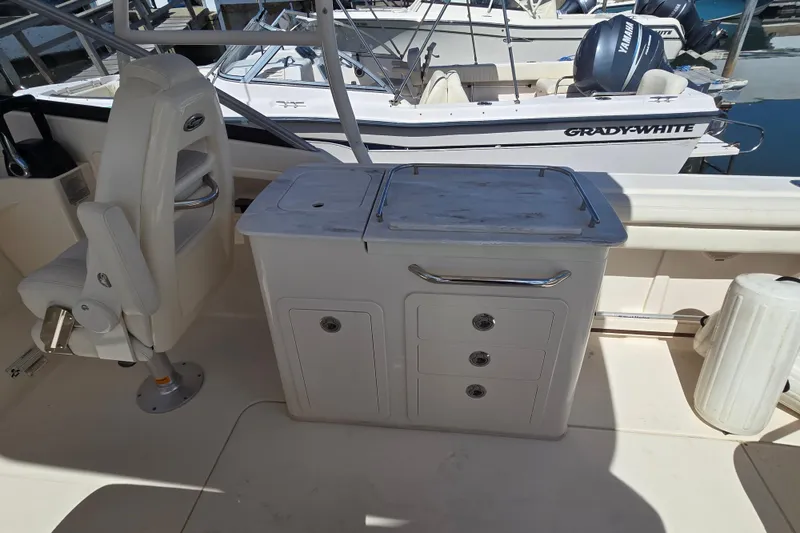 Slide: The Image of 2016 Grady-White Freedom 275 boat interior with seating and storage compartments. - 11