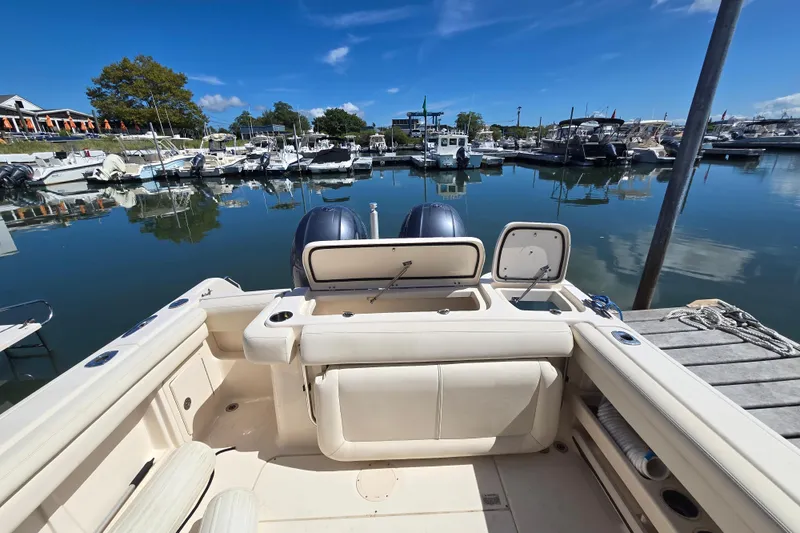 Slide: The Image of 2016 Grady-White Freedom 275 boat docked in a serene marina setting. - 15