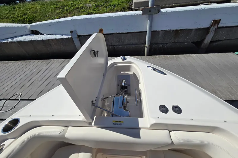 Slide: The Image of 2016 Grady-White Freedom 275 boat anchor compartment open on dock. - 5