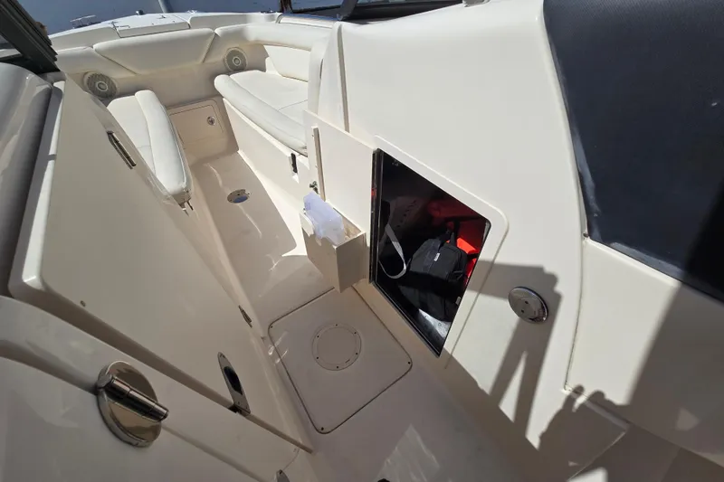 Slide: The Image of 2016 Grady-White Freedom 275 boat interior with storage compartment and seating. - 9