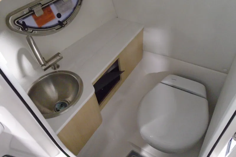 Slide: The Image of Compact bathroom in 2026 Regal LX4 boat with sink and toilet. - 17