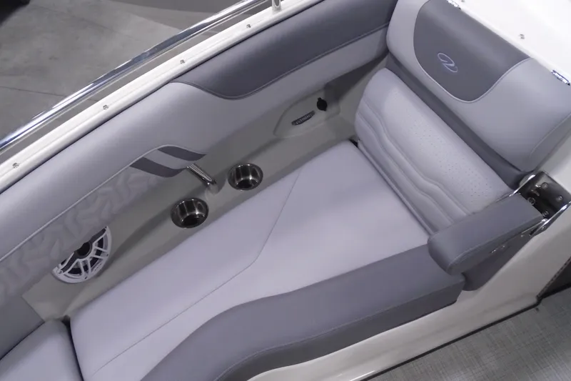 Slide: The Image of 2026 Regal LX4 boat interior with gray seating, cup holders, and speaker. - 20