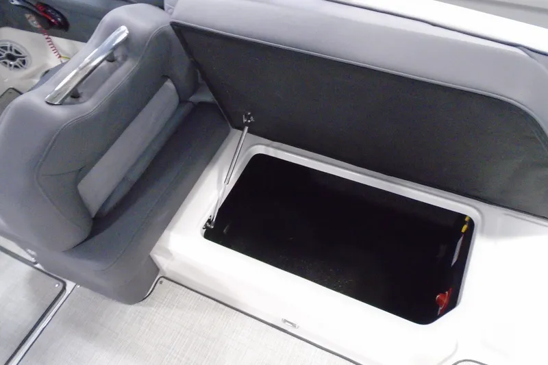 Slide: The Image of 2026 Regal LX4 boat interior with open storage compartment and gray seating. - 21