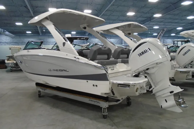 Slide: The Image of 2026 Regal LX4 boat with Yamaha engine in showroom setting. - 3