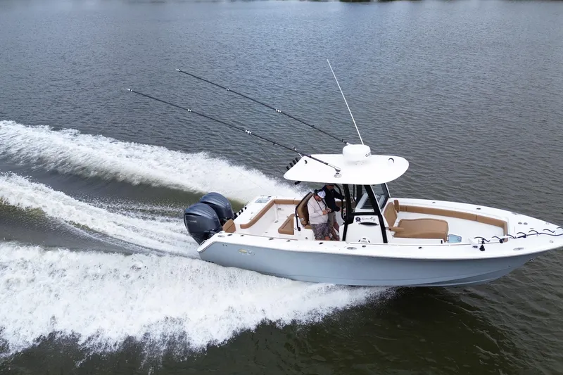 The Image of 2021 Sea Hunt Gamefish 27 Coffin Box cruising on water with fishing rods. - 0