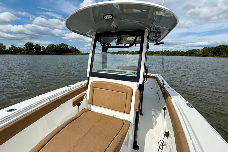 Slide: The Image of 2021 Sea Hunt Gamefish 27 Coffin Box on calm water, featuring spacious seating and sleek design. - 11