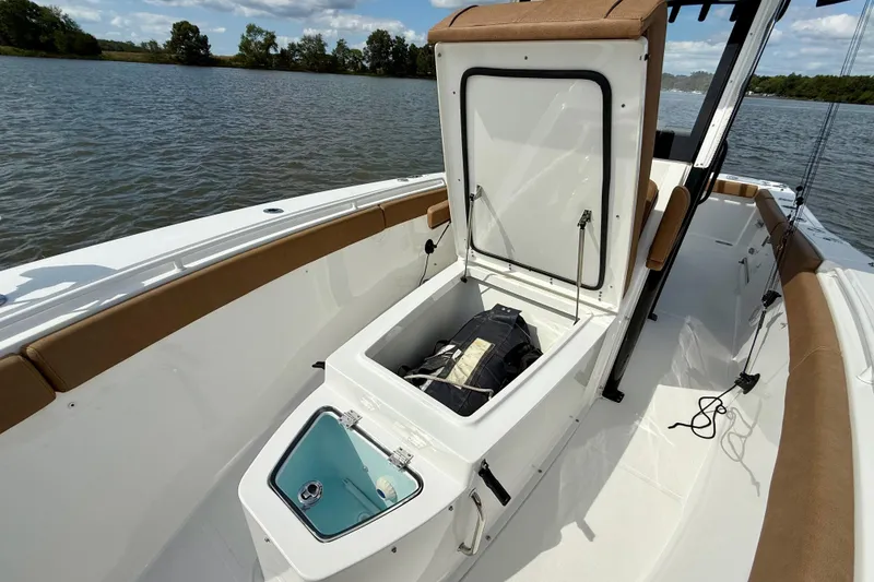 Slide: The Image of 2021 Sea Hunt Gamefish 27 Coffin Box with open storage on a calm lake. - 12