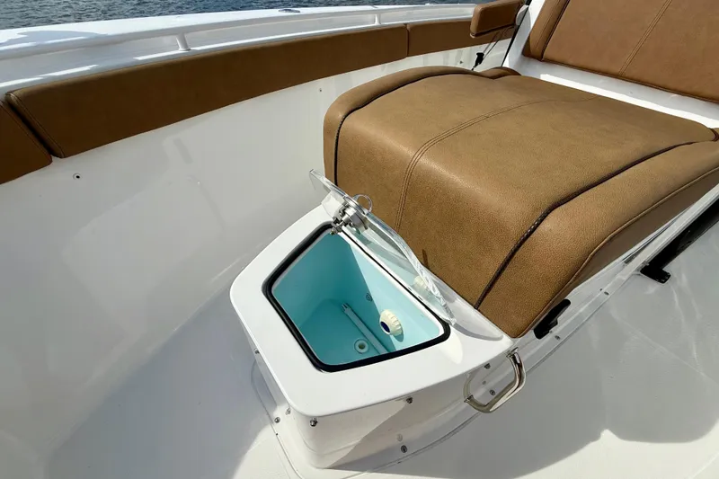 Slide: The Image of 2021 Sea Hunt Gamefish 27 Coffin Box with open storage compartment and cushioned seating. - 13