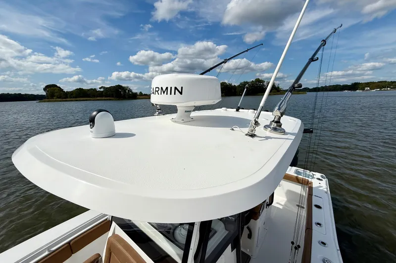 Slide: The Image of 2021 Sea Hunt Gamefish 27 Coffin Box boat with Garmin equipment on calm waters. - 17