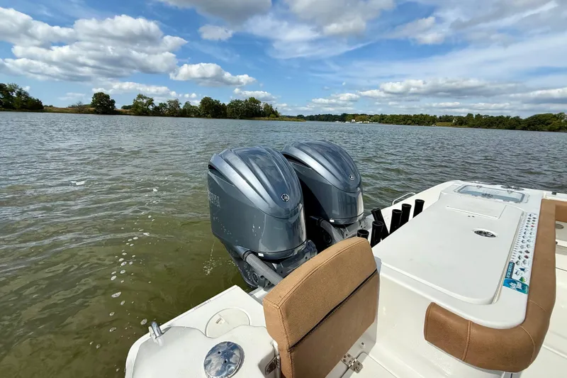 Slide: The Image of 2021 Sea Hunt Gamefish 27 Coffin Box boat with dual engines on a lake. - 20