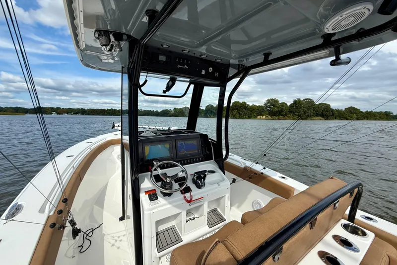 Slide: The Image of 2021 Sea Hunt Gamefish 27 Coffin Box boat interior on a scenic lake. - 23
