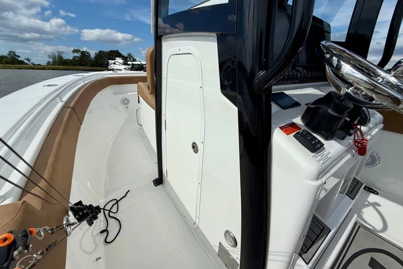 Slide: The Image of 2021 Sea Hunt Gamefish 27 Coffin Box boat interior with steering console and seating. - 36