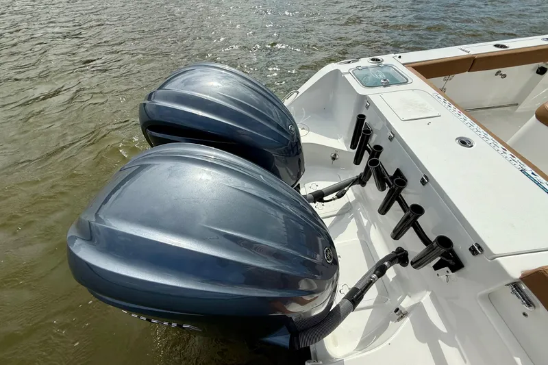 Slide: The Image of 2021 Sea Hunt Gamefish 27 Coffin Box with dual outboard motors on water. - 43