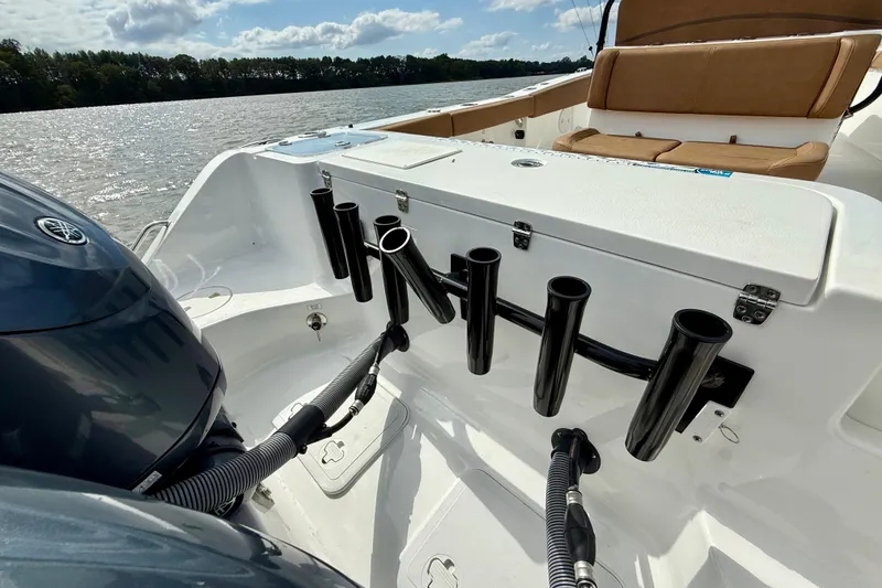 Slide: The Image of 2021 Sea Hunt Gamefish 27 Coffin Box boat with rod holders and seating on a sunny day. - 44