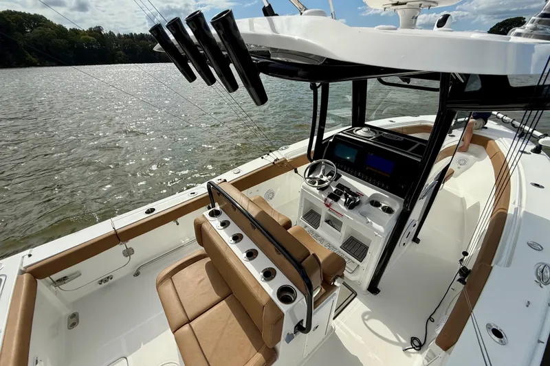 Slide: The Image of 2021 Sea Hunt Gamefish 27 Coffin Box boat interior with helm, seating, and rod holders. - 46