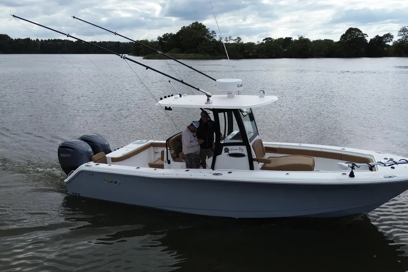 Slide: The Image of 2021 Sea Hunt Gamefish 27 Coffin Box boat on a calm lake. - 5