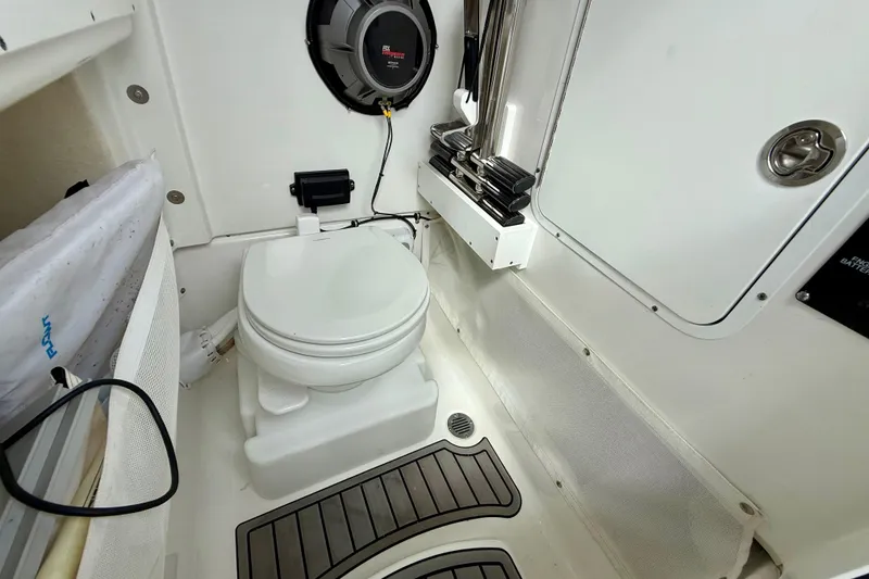 Slide: The Image of 2021 Sea Hunt Gamefish 27 Coffin Box boat interior with toilet and speaker system. - 50