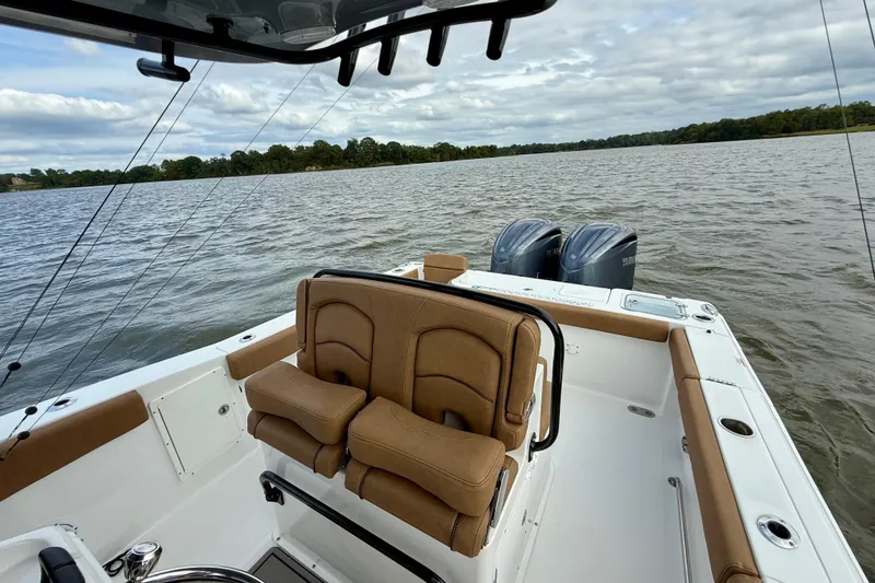 Slide: The Image of 2021 Sea Hunt Gamefish 27 Coffin Box boat on a lake with dual engines. - 52