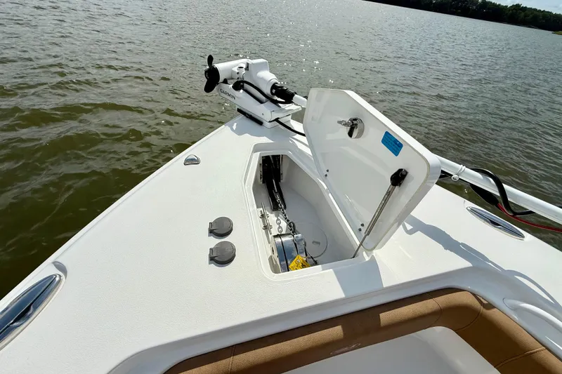 Slide: The Image of 2021 Sea Hunt Gamefish 27 Coffin Box boat with open storage compartment on calm water. - 7