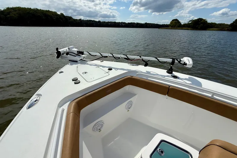 Slide: The Image of 2021 Sea Hunt Gamefish 27 Coffin Box boat on a serene lake with clear skies. - 8