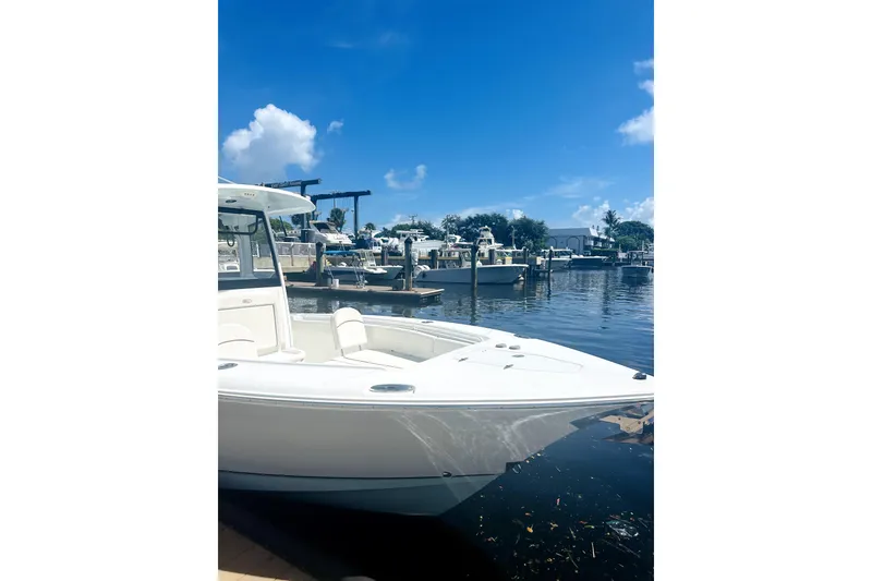 Slide: The Image of 2020 Sea Hunt Gamefish 27 boat docked at marina under clear blue sky. - 3