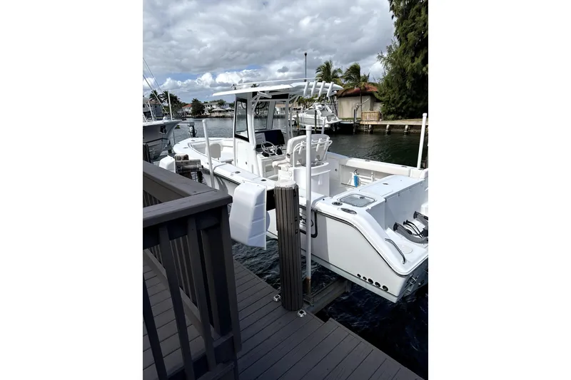 Slide: The Image of 2020 Sea Hunt Gamefish 27 boat docked, featuring forward seating and sleek design. - 5