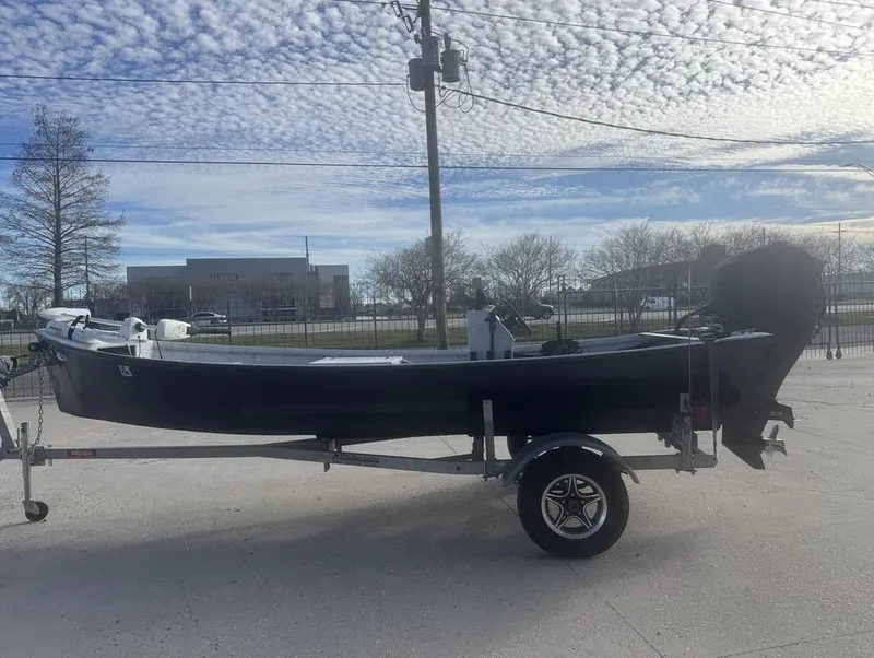 Slide: The Image of 2022 Custom Reno Skiff 16 boat on trailer under cloudy sky. - 5