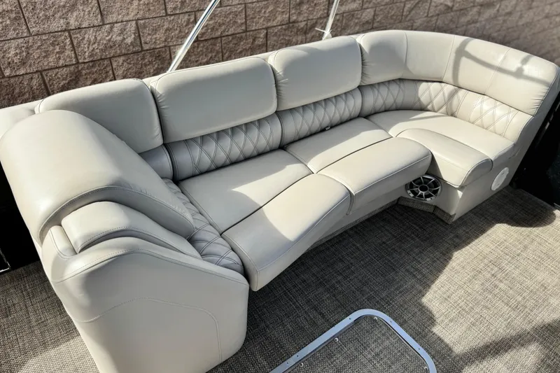 Slide: The Image of Luxurious seating on 2015 Bennington 2575 QCW pontoon boat, featuring plush, quilted upholstery. - 14