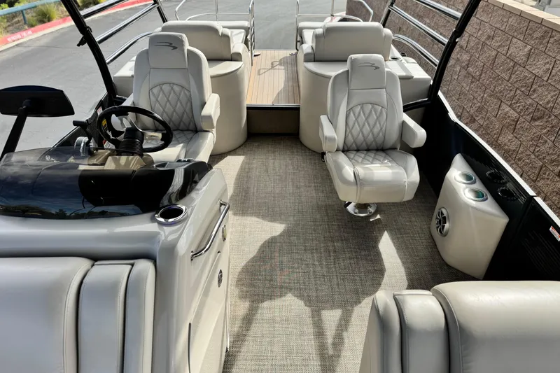 Slide: The Image of 2015 Bennington 2575 QCW pontoon boat interior with luxurious seating and modern helm. - 19