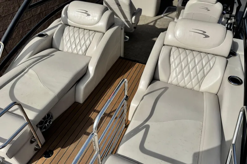Slide: The Image of 2015 Bennington 2575 QCW boat interior with luxurious white leather seating. - 23