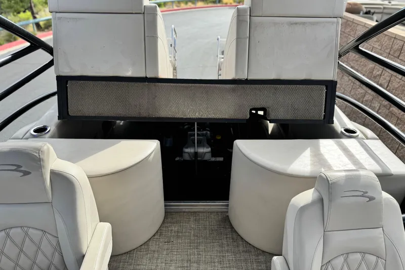 Slide: The Image of 2015 Bennington 2575 QCW boat interior with seating and storage compartments. - 25